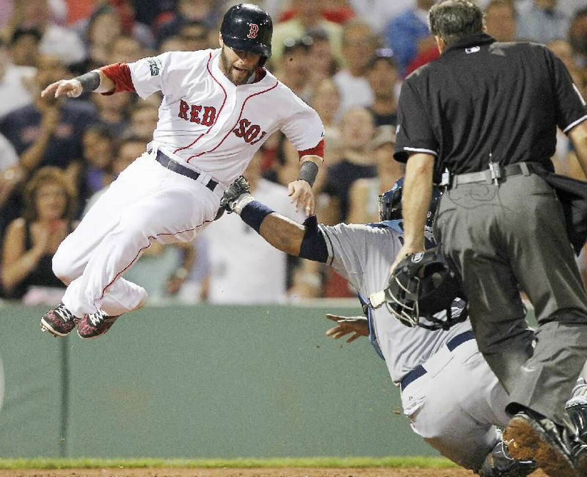 ASSOCIATED PRESS Tampa Bay Rays catcher Jose Molina, right back, tags Boston Red Sox shortstop Dustin Pedroia, left, at home plate in the sixth inning of Saturday's game at Fenway Park in Boston.