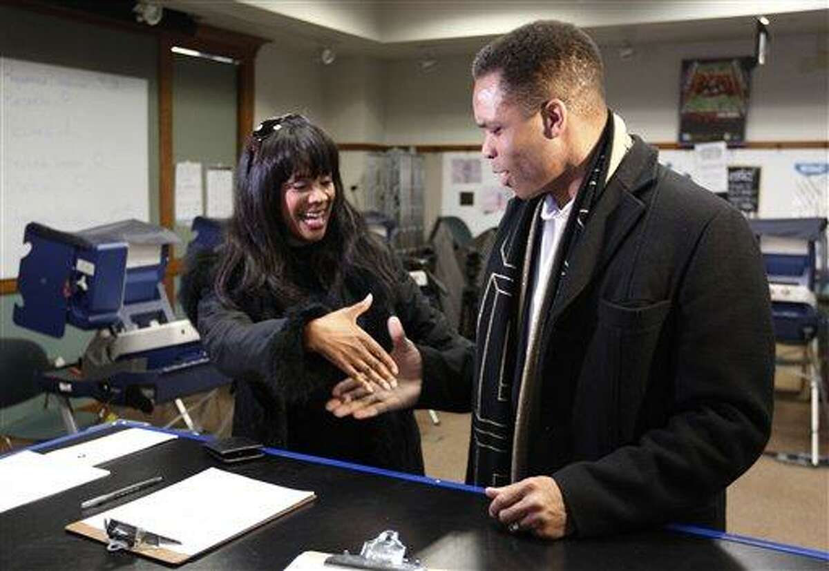 Rep. Jesse Jackson Jr., D-Ill., and his wife, Chicago Alderman Sandi Jackson, asking each other for their support and votes as they arrive at a polling station for early voting in Chicago. AP Photo/M. Spencer Green, File