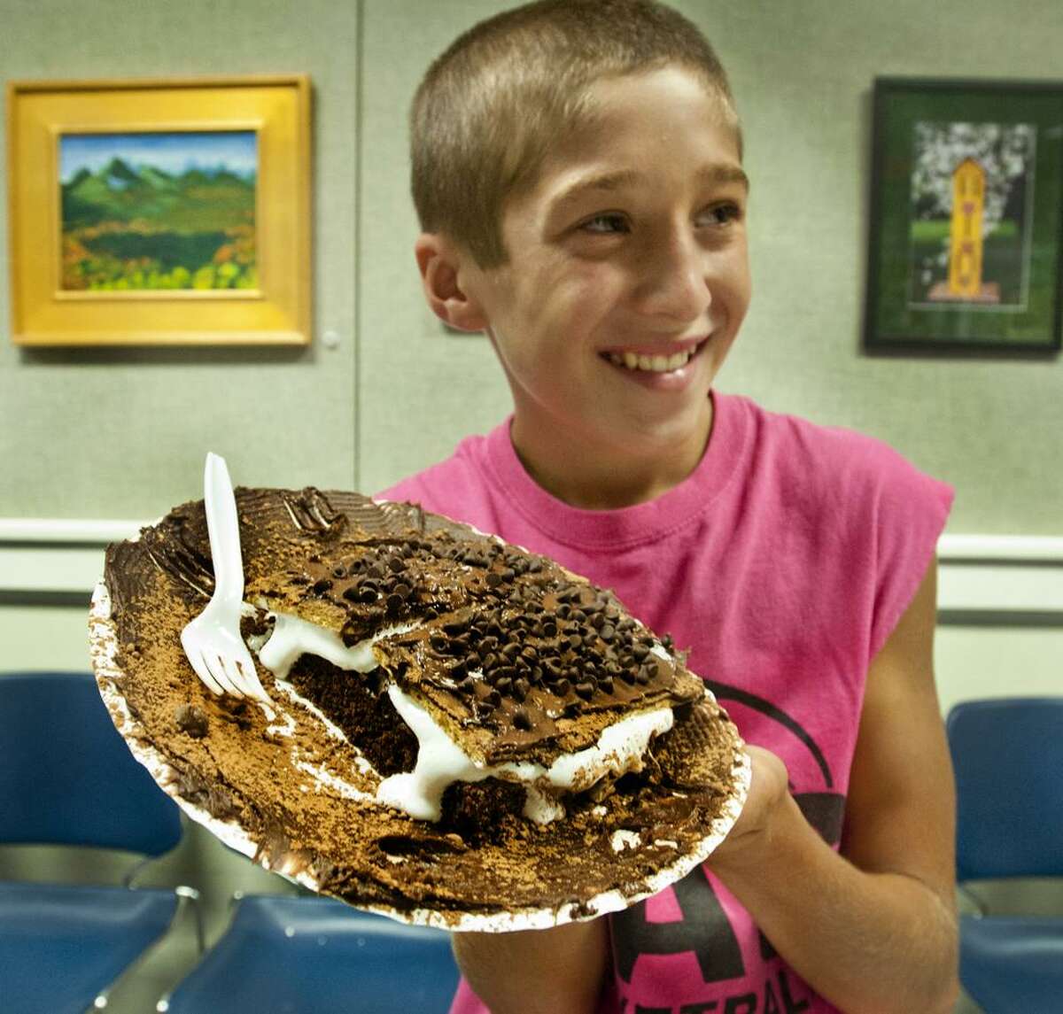Matthew D'Onofrio, 12, of Orange, holds up his winning entry "Stuffed S'More Surprise" at the kids Iron Chef competition held at the Case Memorial Library. Melanie Stengel/Register