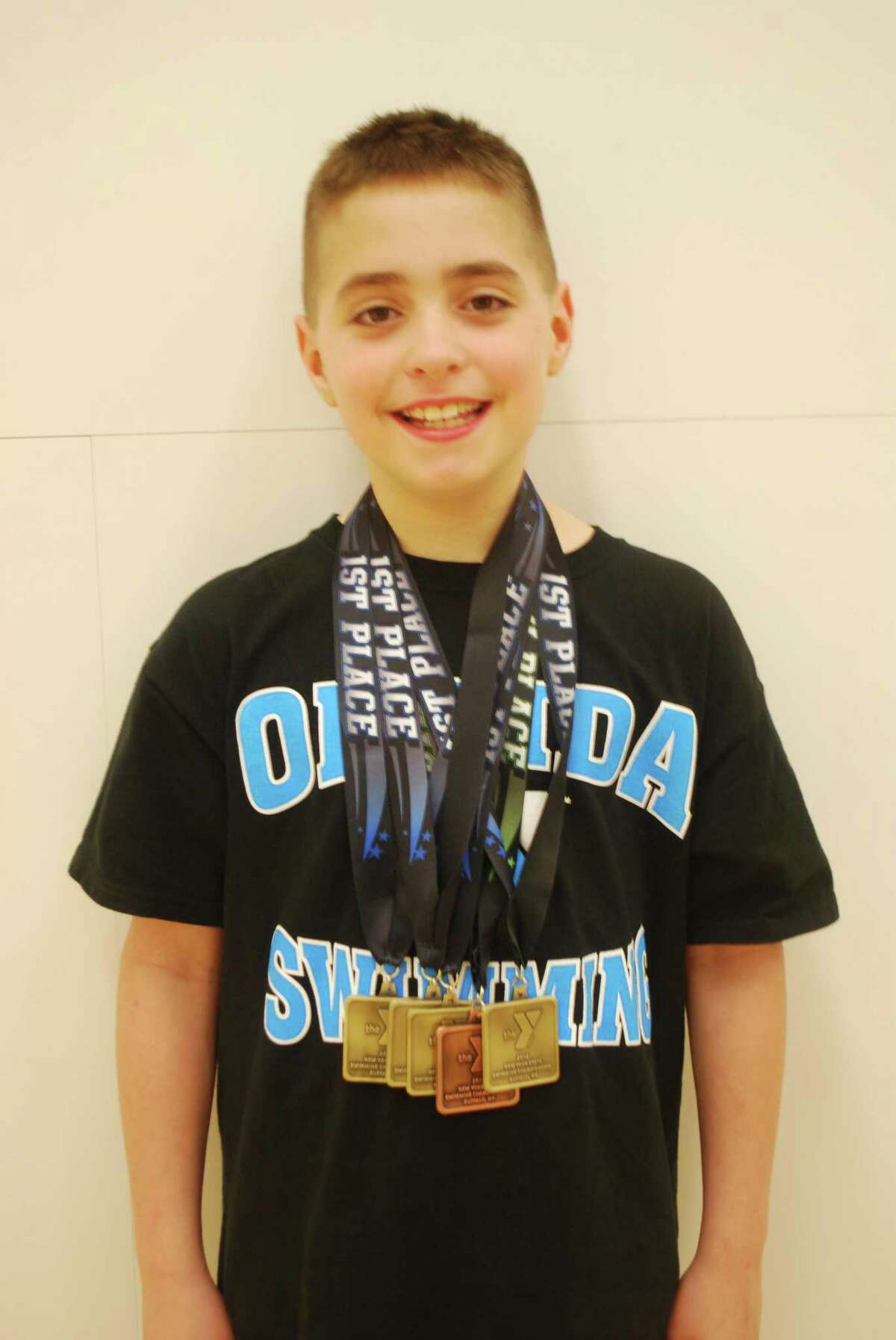 Submitted Photo Oneida YMCA Dolphins U8 swimmer Aidan Hicks won three individual championships and one relay championship with Ajay Hicks, Drew Hicks and Lucas Tracy at the state meet in Buffalo.