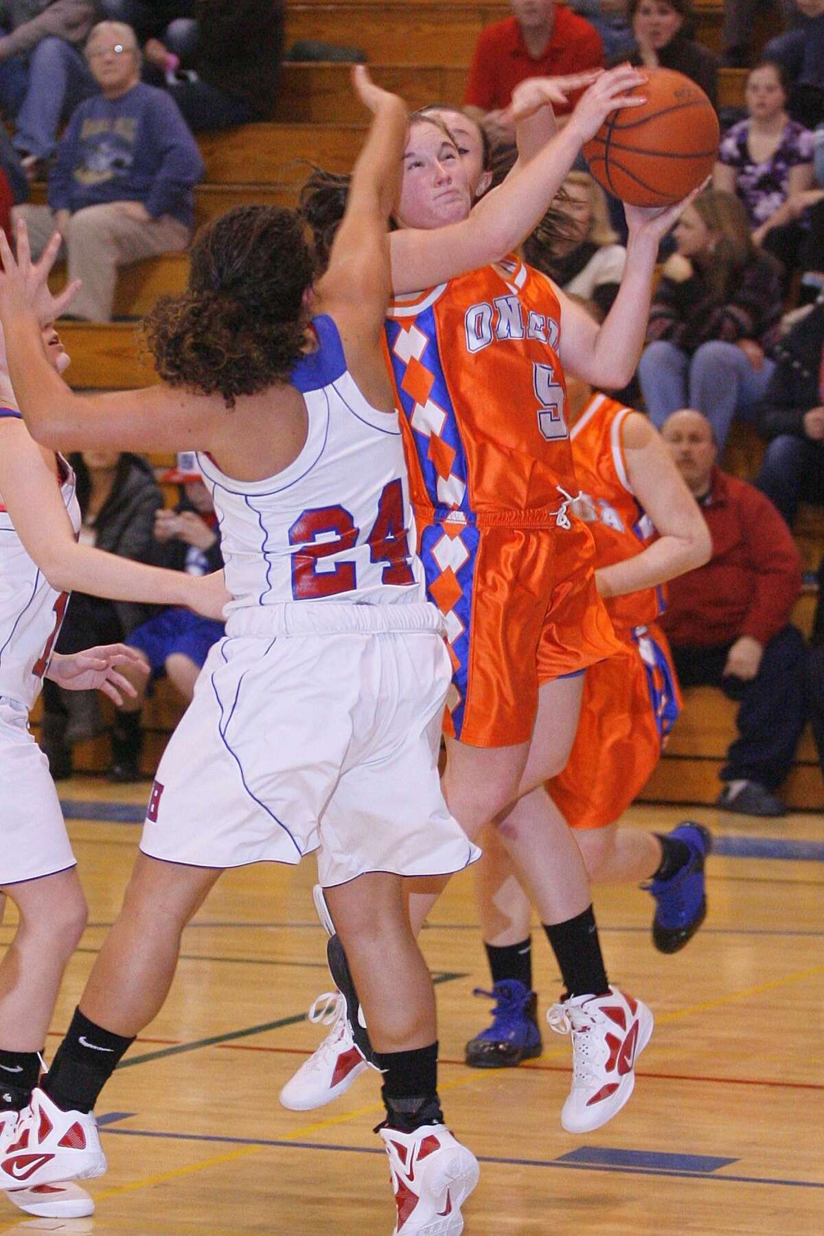 Dispatch Staff Photo by JOHN HAEGER twitter.com/oneidaphoto Oneida's Jenna Didio (5) goes up for two as New Hartford's Ashley Alex Romano (24) defends in the second half of the game on Friday Jan. 20, 2012 in New Hartford.