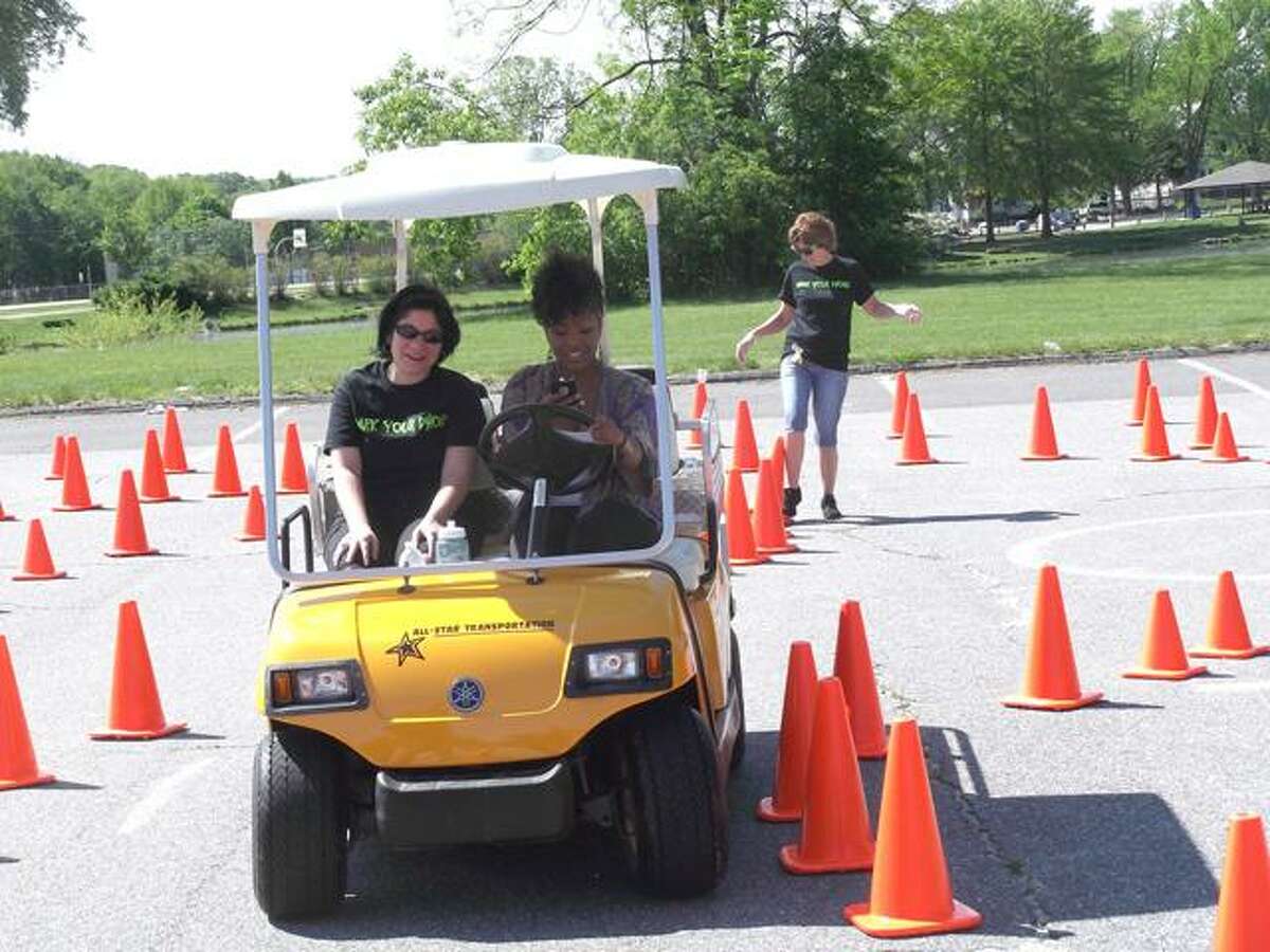 RICKY CAMPBELL/ Register Citizen The Mayor's Committee on Youth, All-Star Transportation, Torrington Police and Connecticut State Police joined forces Friday to educate Torrington High School students on safe driving techniques and better decision-making, as they enter into prom season and the summer. The second annual event allowed teens to text while manuvering a golf cart through a cone maze. It wasn't easy.