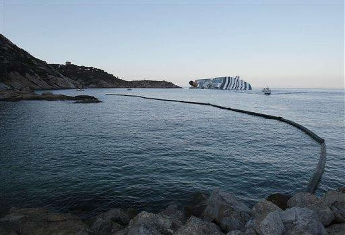 A floating barrier is used Wednesday to contain any eventual oil spill from cruise ship Costa Concordia leaning on its side after running aground the tiny Tuscan island of Giglio, Italy. In response to a question at a press conference in London Wednesday, Italian premier Mario Monti acknowledged concern about a potential leak of 500,000 gallons of fuel aboard the ship. He said authorities had made limiting and preventing leaks a priority, as well as caring for victims. Associated Press
