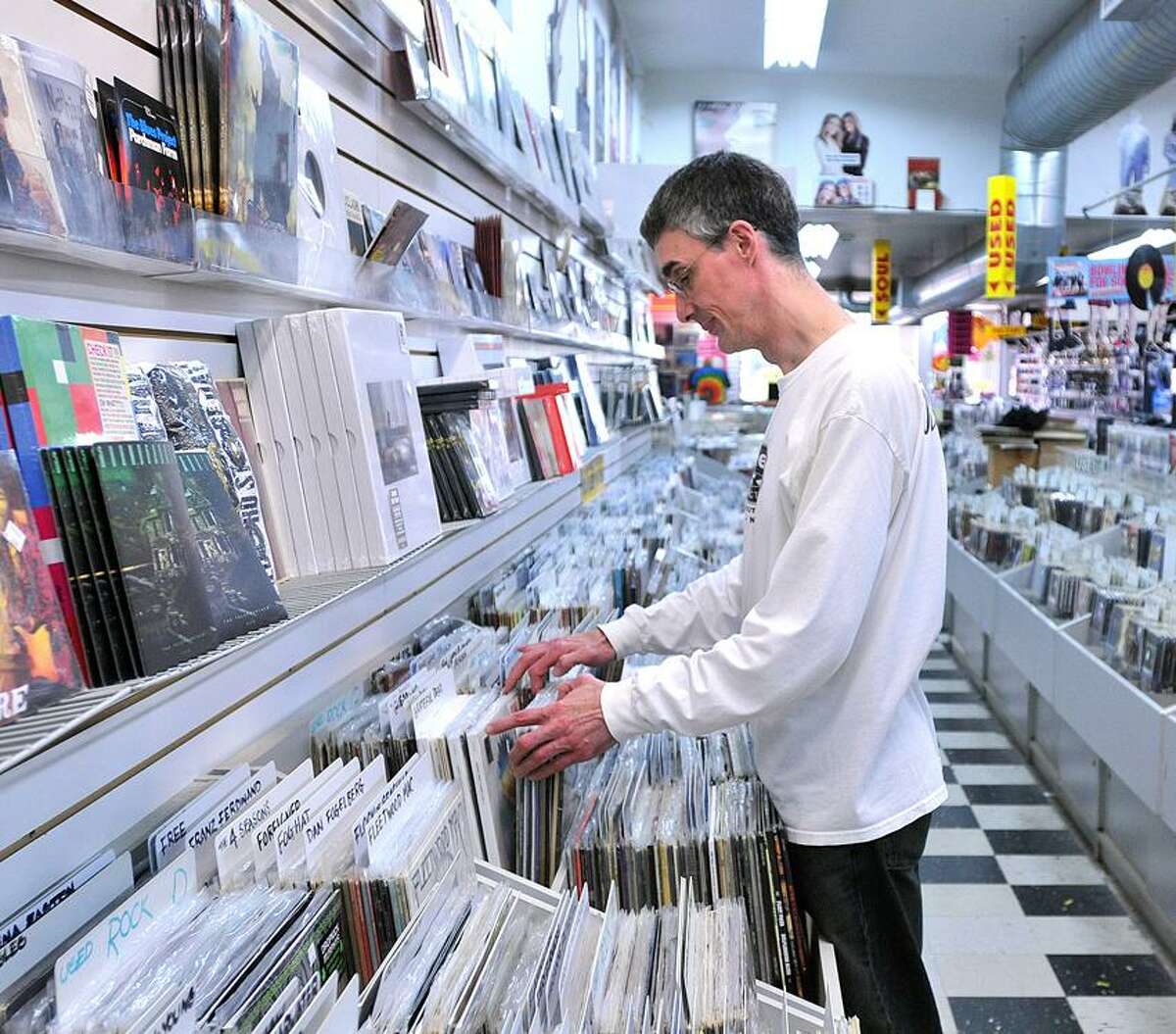 Employee Bob Briar sorts records at Cutler's Record and Tapes, which is closing at the end of June. Briar has worked at the store since 1974, when he was 17 years old. Peter Casolino/New Haven Register