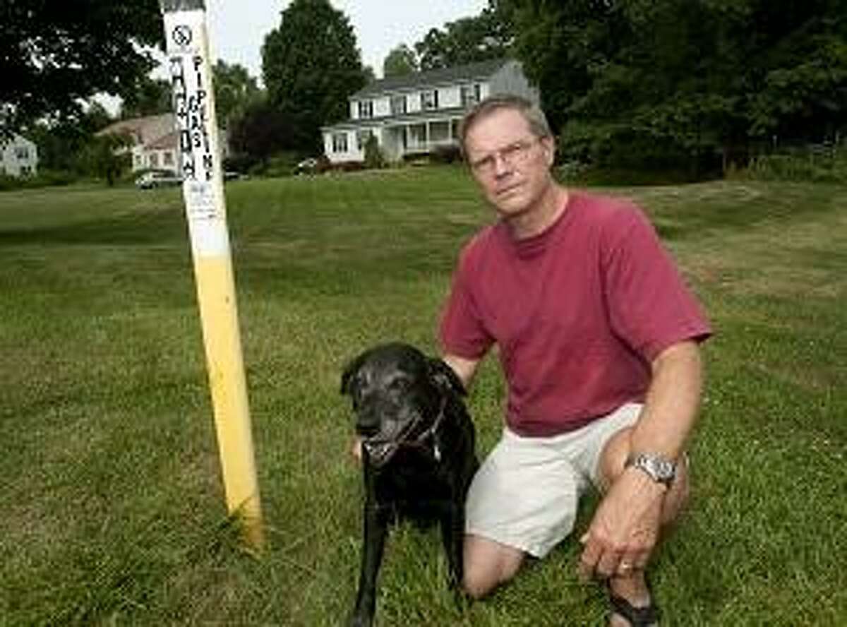 Brookfield-Steve Kohlase, of Brookfield, with his dog Mattie in front of his home. Before noise from the gas pipeline was audible to the humans in the home Mattie became agitated , as she does when she hears an approaching storm. The dog was placed on Prozac for three months. Melanie Stengel/Register