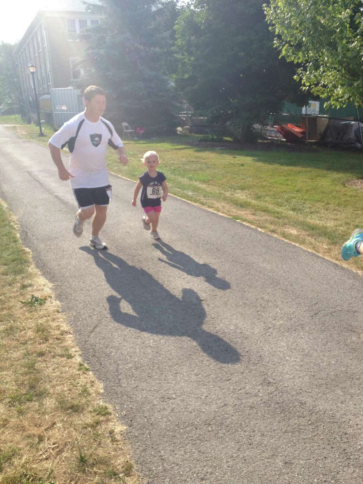 Kyle Graves and his daughter Dalaney approach the finish line at the Fun Run at Morrisville State College on July 14, 2012. Submitted Photo