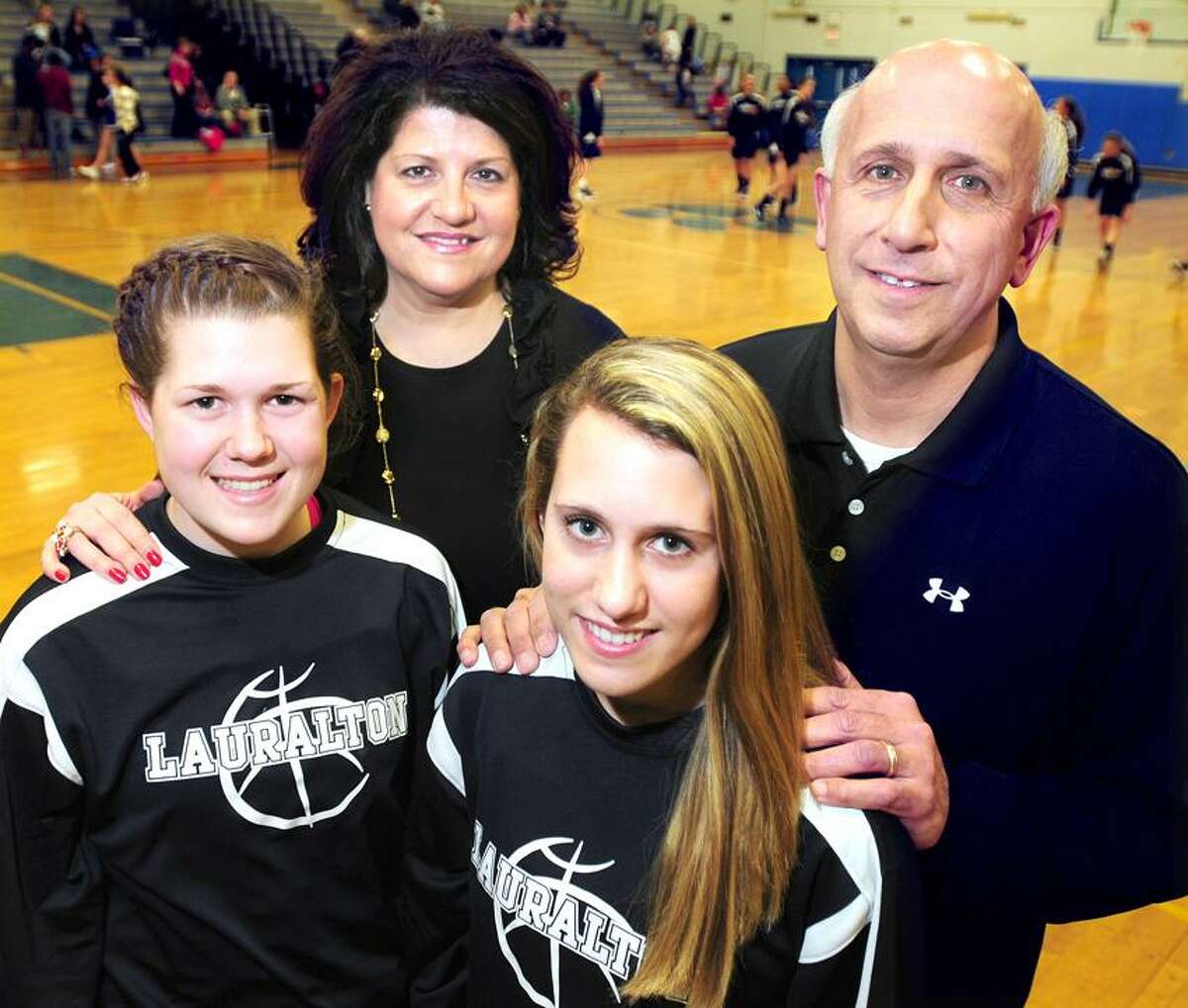 Carly Fabbri (front left) and Michelle DeSantis (front right) of Lauralton Hall are photographed with their parents Tricia Fabbri (back left) and Joe DeSantis (back right0 before a game at Bunnell in Stratford on 1/10/2012.Photo by Arnold Gold/New Haven Register AG0434E