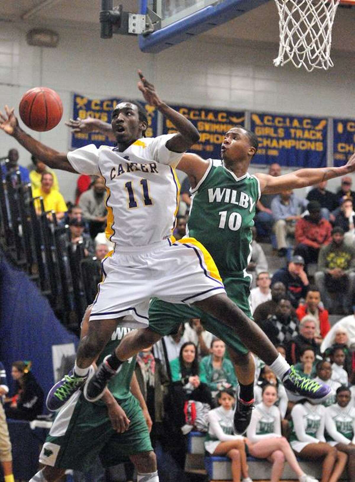 Stratford--Career's Treyvon Moore takes the foul from Wilby's Marcus Robinson during the first half. Photo- Peter Casolino/New Haven Register 03/13/12