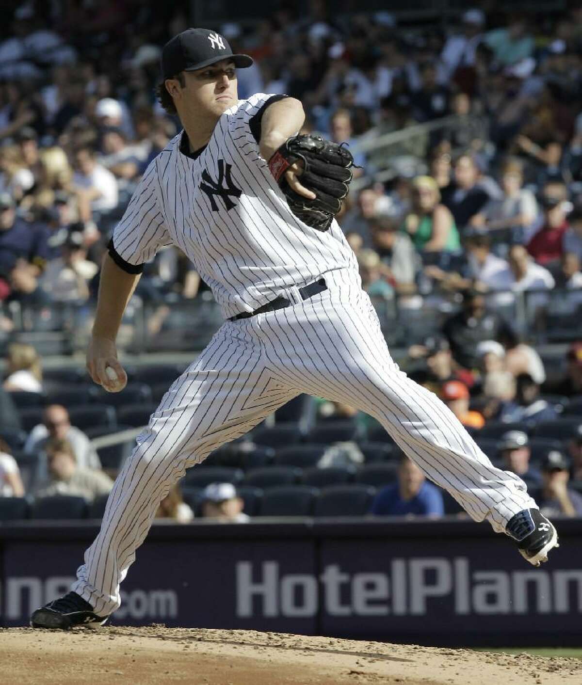 ASSOCIATED PRESS New York Yankees pitcher Phil Hughes throws in the third inning of Saturday's game against the Seattle Mariners at Yankee Stadium in New York. The Yankees won 6-2.