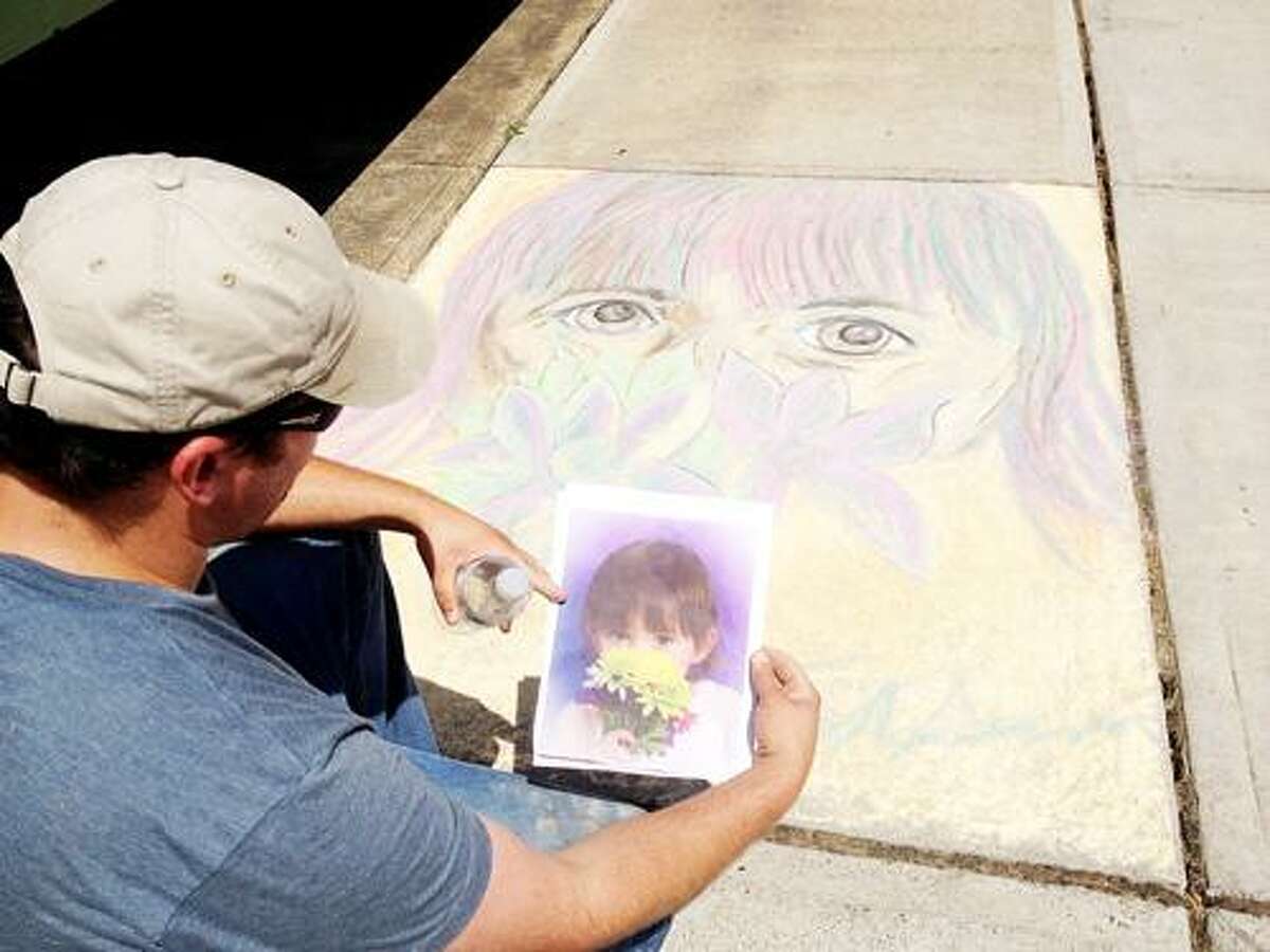Photo by JOLENE CLEAVER Tom Gordon draws a picture of his daughter at Sylvan Beach's Chalk the Walk on Sunday, July 8, 2012.