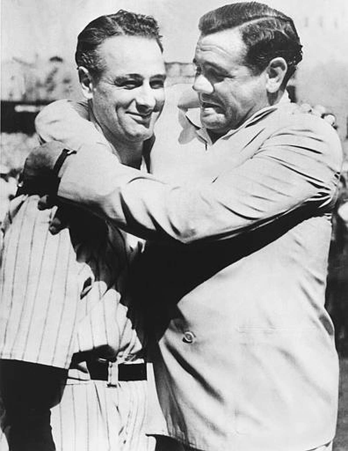 Babe Ruth, right, immortal New York Yankee baseball player comforts Lou Gehrig, who was almost too moved to speak to the vast throng which acclaimed him at Yankee Stadium July 4, 1939 where the Yankees met the Washington Senators in a doubleheader. Gehrig, famed iron man of the Yankees, was honored by players and fans. As an added honor, the world championship flag that the Yankees won in 1927 with a team hailed as one of baseball's greatest was unfurled at the stadium. (AP Photo)