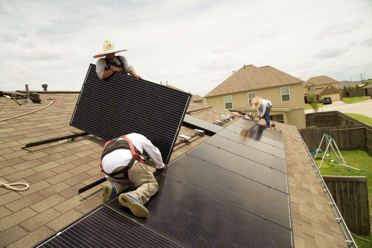 Workers from Alba Solar install solar panels in Katy Texas.