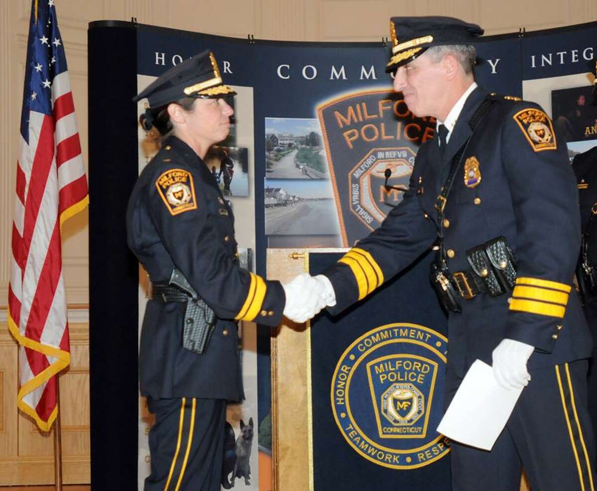 Milford Police Chief Keith L. Mello, right, congratulates Deputy Police Chief Tracy Mooney during a promotional swearing-in ceremony Thursday at Milford City Hall. Peter Hvizdak/Register January 4, 2012 ph2435 # Connecticut