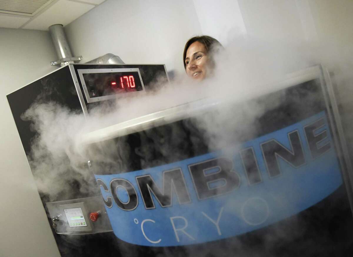 Operations manager Christina Vitale demonstrates cryotherapy in the Cryosauna at Combine Training in Greenwich, Conn. Tuesday, July 18, 2017. Cryotherapy exposes the body to extremely low temperatures for a short period of time and is said to prompt quick recovery after a workout and release endorphins to give a feeling similar to a "runner's high."