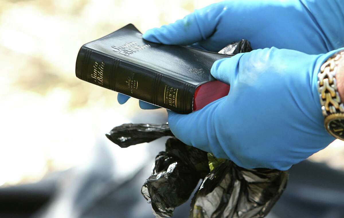 Officials recover a Bible from a body in Brooks County in 2013, when Houston Chronicle reporter Mark Collette was researching migrant deaths.
