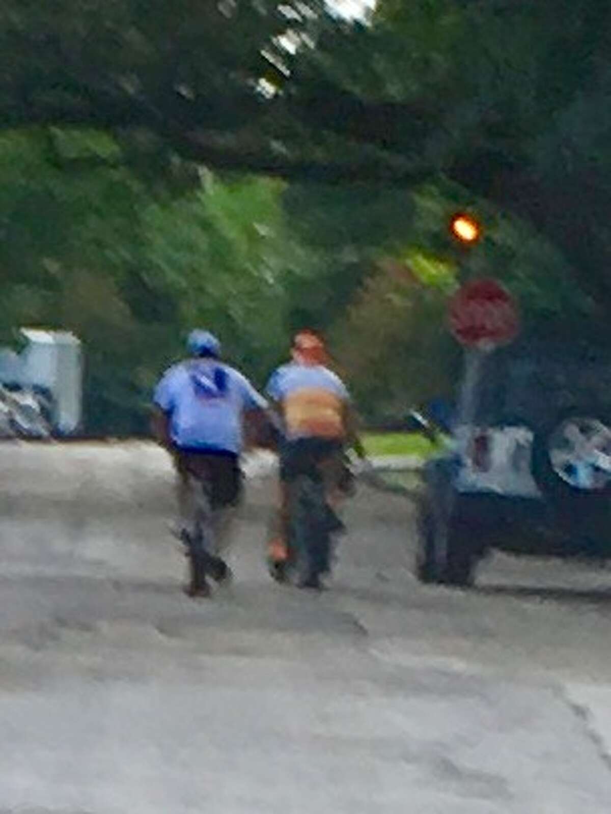 The Harris County Pct. 1 Constable's Office is looking for information on the cyclists shown in this photo, after an assault victim says the cyclist on the right in the orange and yellow Astros jersey attacked him through a car window on July 19. 