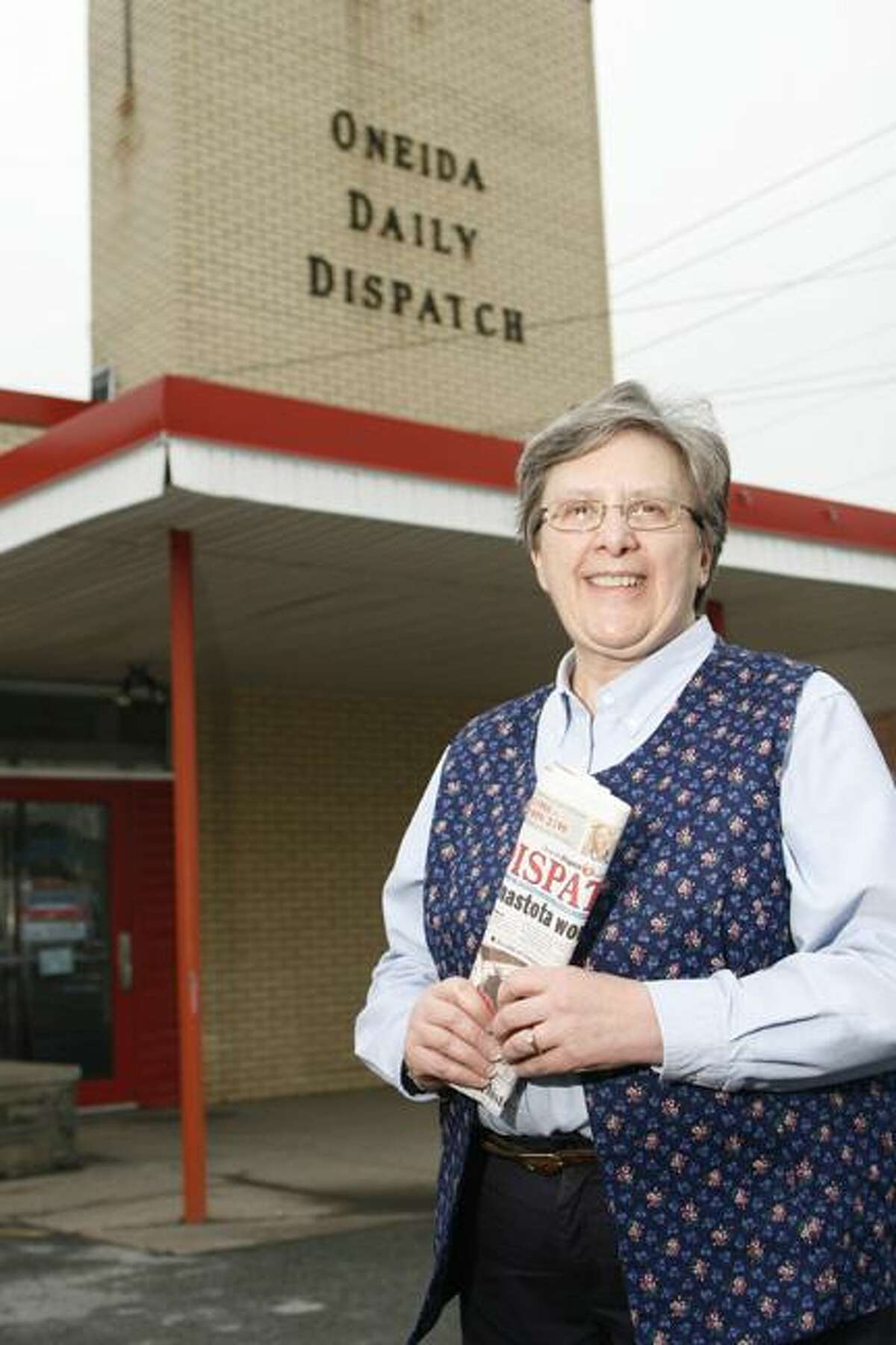 Dispatch Staff Photo by JOHN HAEGER (Twitter.com/OneidaPhoto)Marcia Warham stands in front of The Dispatch building on Broad Street.