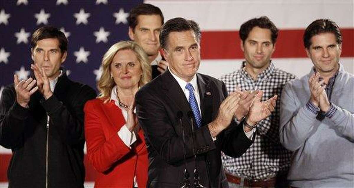 FILE -- In a Jan. 3, 2012 file photo Republican presidential candidate, former Massachusetts Gov. Mitt Romney applauds after addressing a crowd of supporters with his wife Ann and their sons Matt, Josh, Craig and Tagg behind him during a Romney for President Iowa Caucus night rally in Des Moines, Iowa. During what may be the most important week of Mitt Romney's political career, the Republican presidential contender's five sons are sharing family secrets like never before. (AP Photo/Charlie Neibergall, file)