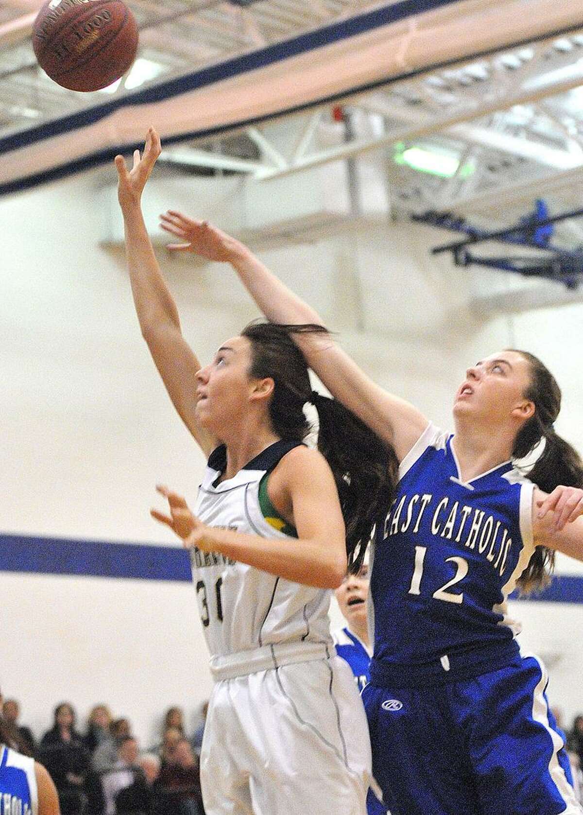 Milford-- Lauralton Hall's Cassie Gildea takes the foul from East Catholic's Elizabeth Brasa during the first quarter . Photo- Peter Casolino/New Haven Register 03/01/12