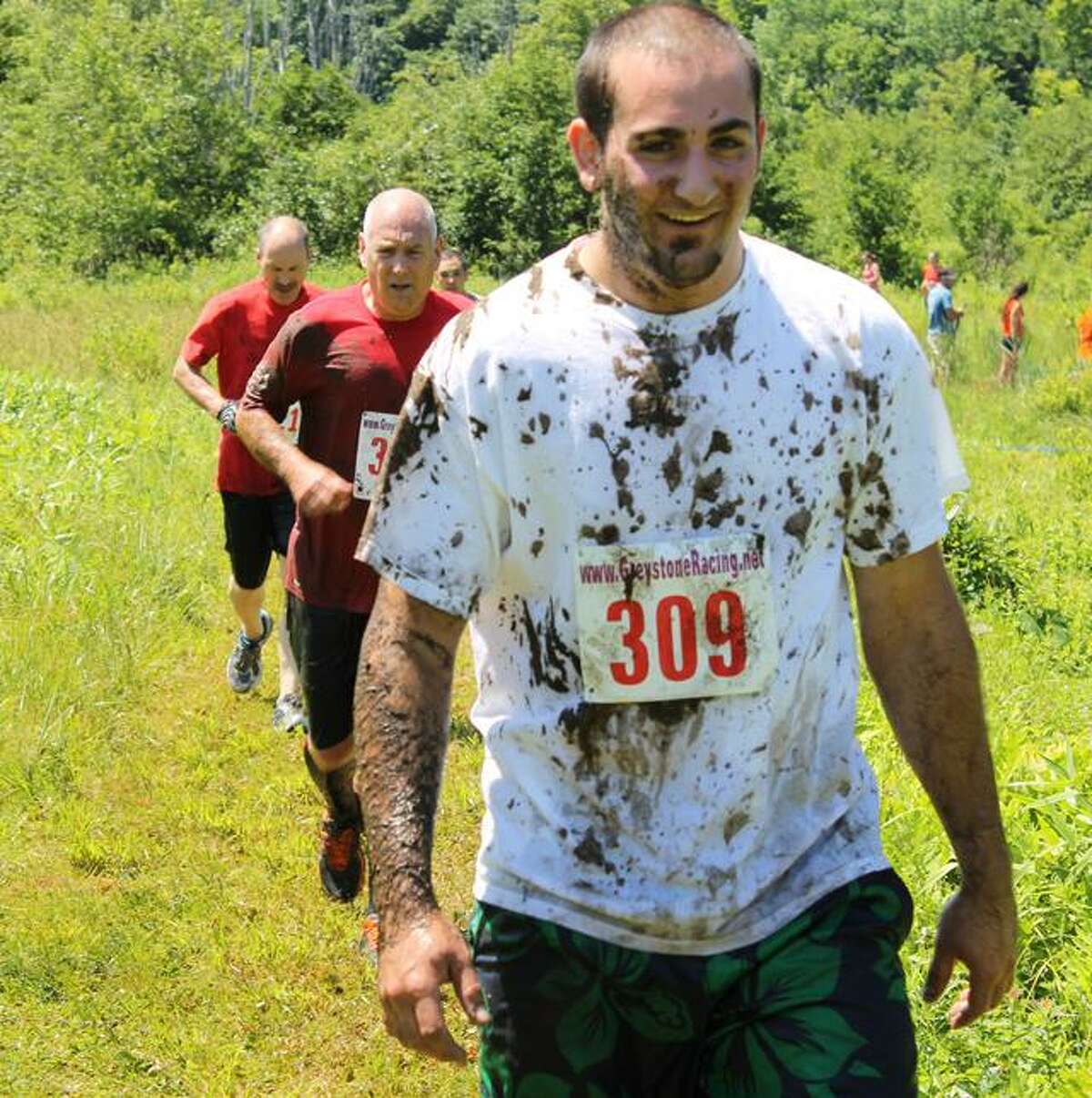 MATT DeRIENZO/ Register Citizen Participants of the first-ever Wyld Mud Run 5K got a little dirty Saturday at John A. Minetto State Park after crawling through mud, running and swimming through water, climbing walls and racing around the wooded trails. The race tested both endurance and strength, while allowing racers to have some fun and benefit the Northwest Connecticut YMCA.