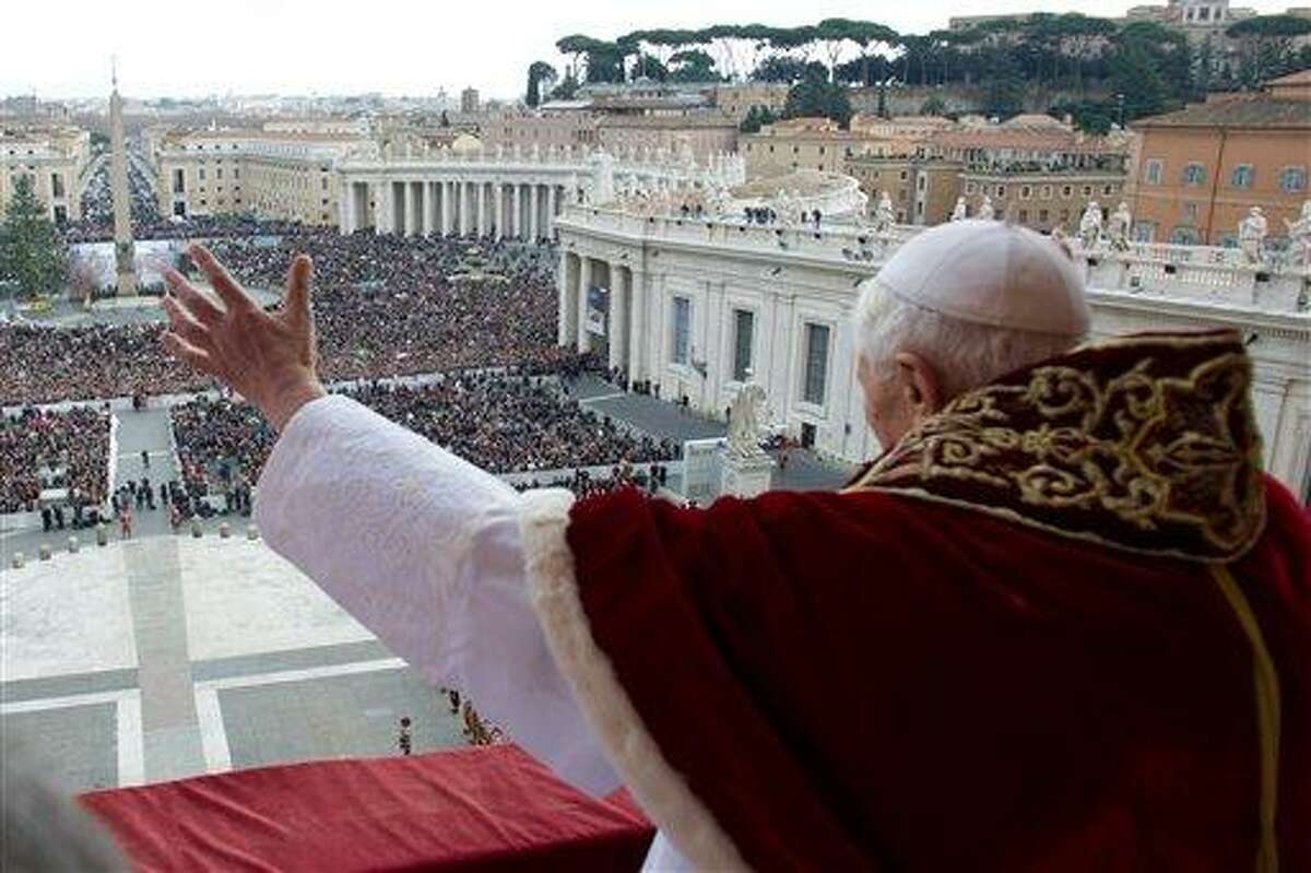 In this photo provided by Vatican paper L'Osservatore Romano, Pope Benedict XVI delivers his "Urbi et Orbi" (to the City and to the World) message from the central balcony of St. Peter's Basilica, at the Vatican, Tuesday, Dec. 25, 2012. Pope Benedict XVI wished Christmas peace to the world, decrying the slaughter of the "defenseless" in Syria and urging Israelis and Palestinians to find the courage to negotiate. Delivering the Vatican's traditional Christmas day message from the central balcony of St. Peter's Basilica, a weary-looking and hoarse-sounding Benedict on Tuesday also encouraged Arab spring nations, especially Egypt, to build just and respectful societies. (AP Photo/Gregorio Borgia)