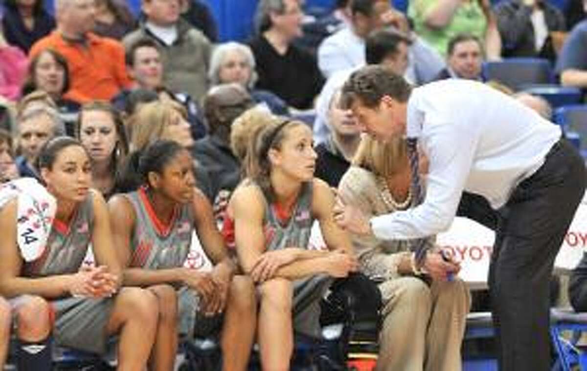 ASSOCIATED PRESS Connecticut head coach Geno Auriemma talks to (L-R) guard Bria Hartley, guard Tiffany Hayes, and guard Caroline Doty about their poor play after he yanks them all with three minutes left in Monday night's game against Notre Dame at the XL Center in Hartford. Notre Dame pulled away in the 2nd half and won 72-59, giving them their first outright Big East Women's regular season championship.