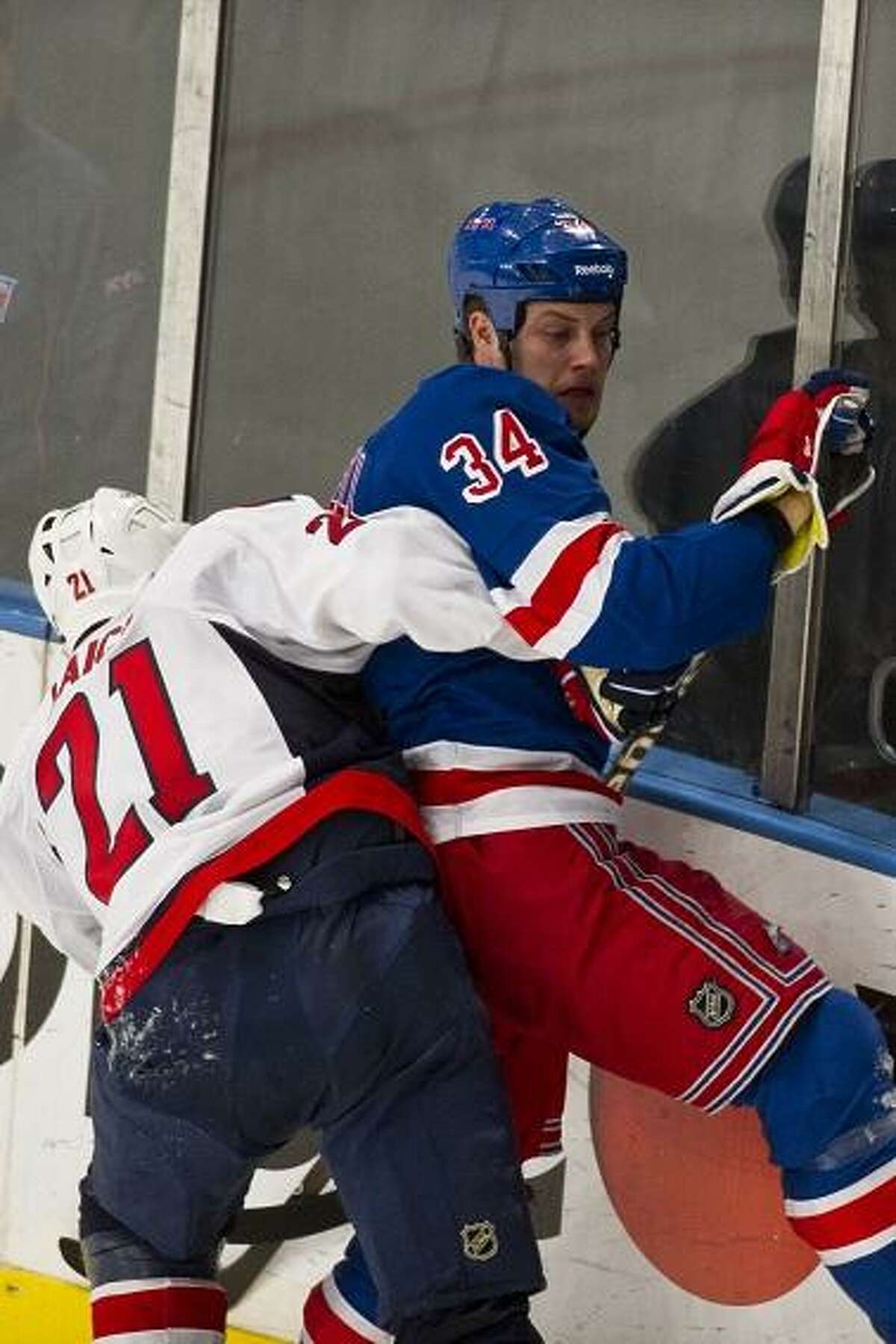 April 30, 2012: Washington Capitals center Brooks Laich (21) drives New York Rangers center John Mitchell (34) into the boards during game 2 of the Eastern Conference Semi Finals at Madison Square Garden in Manhattan, New York . (Cal Sport Media via AP Images)