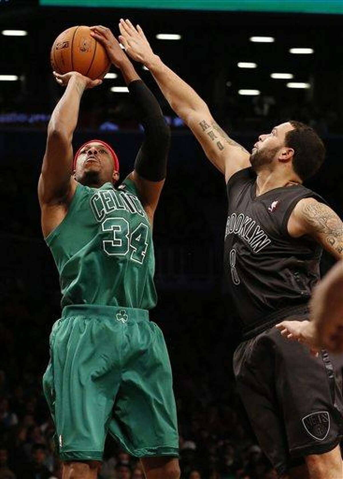 Boston Celtics forward Paul Pierce (34) shoots against Brooklyn Nets guard Deron Williams (8) in the second half of their NBA basketball game at Barclays Center, Tuesday, Dec. 25, 2012, in New York. Boston won 93-76. (AP Photo/John Minchillo)