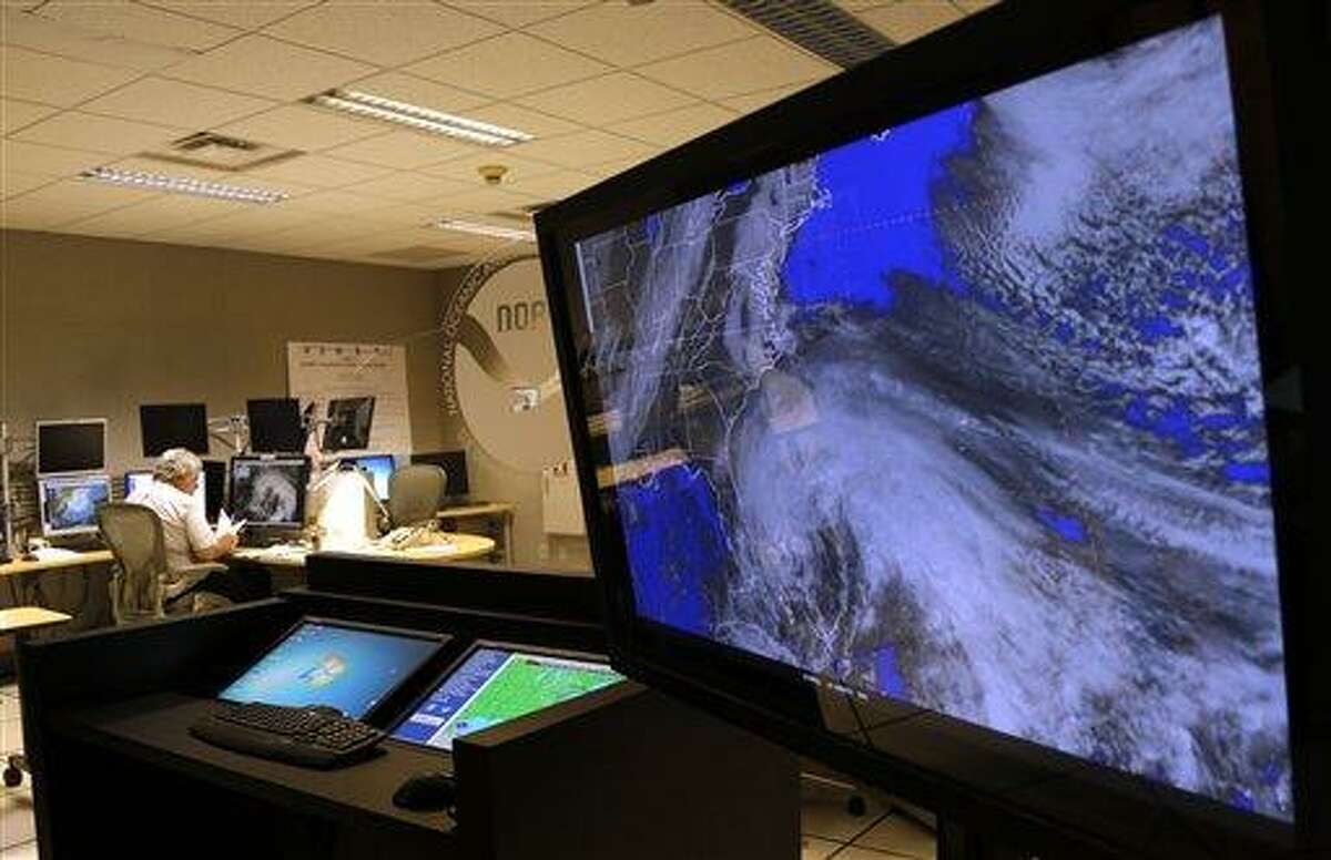 A satellite image of Hurricane Sandy is shown on a computer screen at the National Hurricane Center in Miami on Friday, Oct. 26, 2012. Sandy left 21 people dead as it moved through the Caribbean, following a path that could see it blend with a winter storm and reach the U.S. East Coast as a super-storm next week.