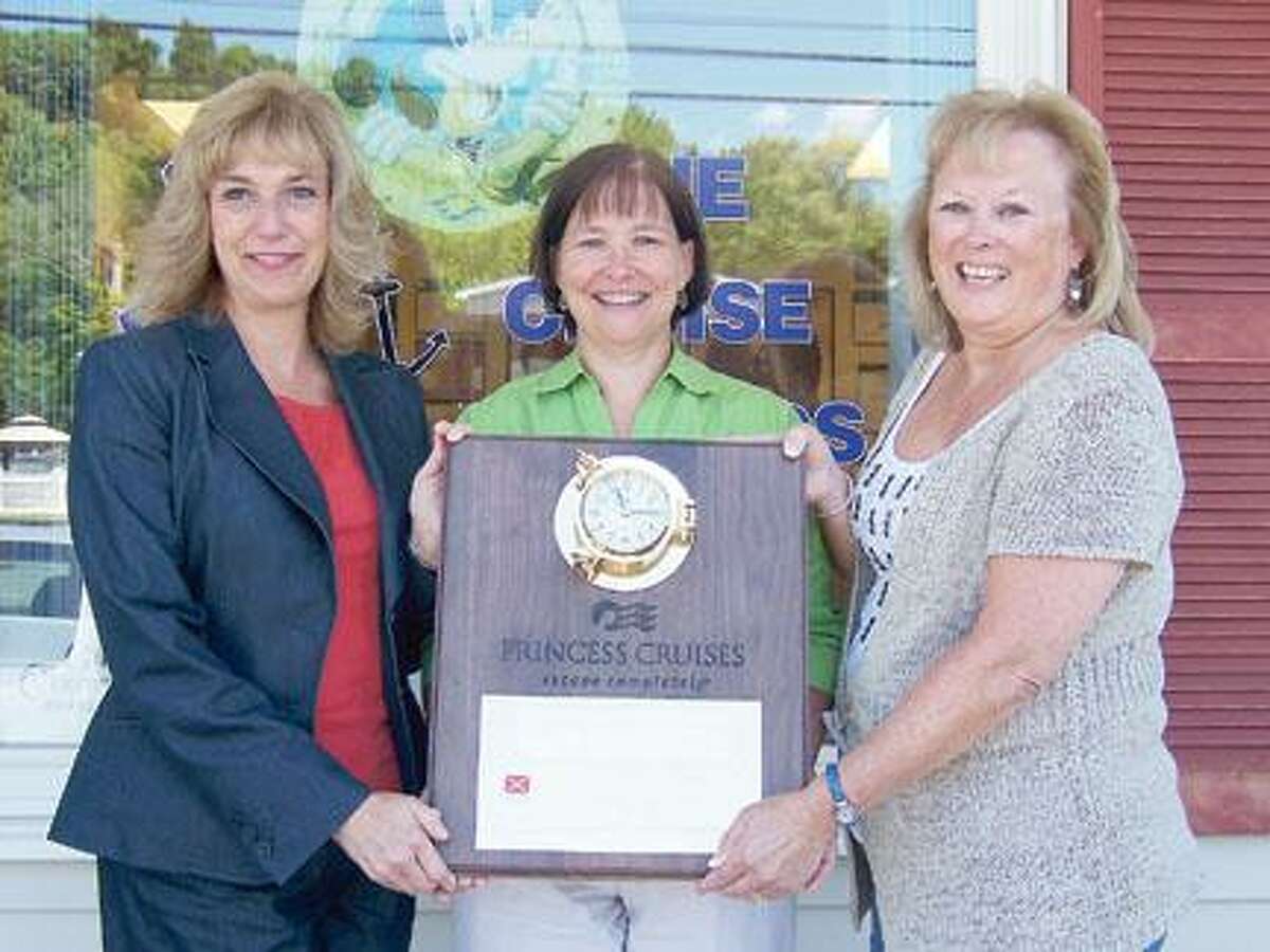 Submitted Photo The award clock was presented to Brenda Gray of Clinton and Deborah Lawendowski of Marcy, co-owners of The Cruise Wizards, by Debby Hege, business development manager of Princess Cruises.