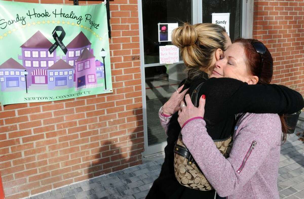 Sandy Hook Healing Project founder Heather Gunn-Rivera of New York City left embraces volunteer Reiki instructor Wendy Strauss, also of NYC, outside the Project's Newtown location. Gunn-Rivera set up the Healing Project to help those affected by the Sandy Hook shooting with a variety of therapeutic assistance. Mara Lavitt/New Haven Register12/24/12