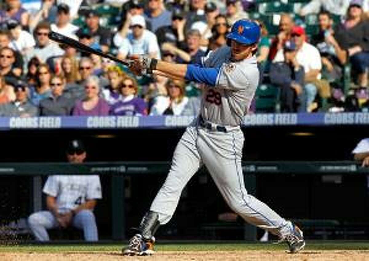 ASSOCIATED PRESS New York Mets first baseman Ike Davis follows the flight of his RBI-single off Colorado Rockies relief pitcher Matt Belisle in the 11th inning of the Mets' 6-5 victory in Denver on Sunday. Davis drove in David Wright with the single.
