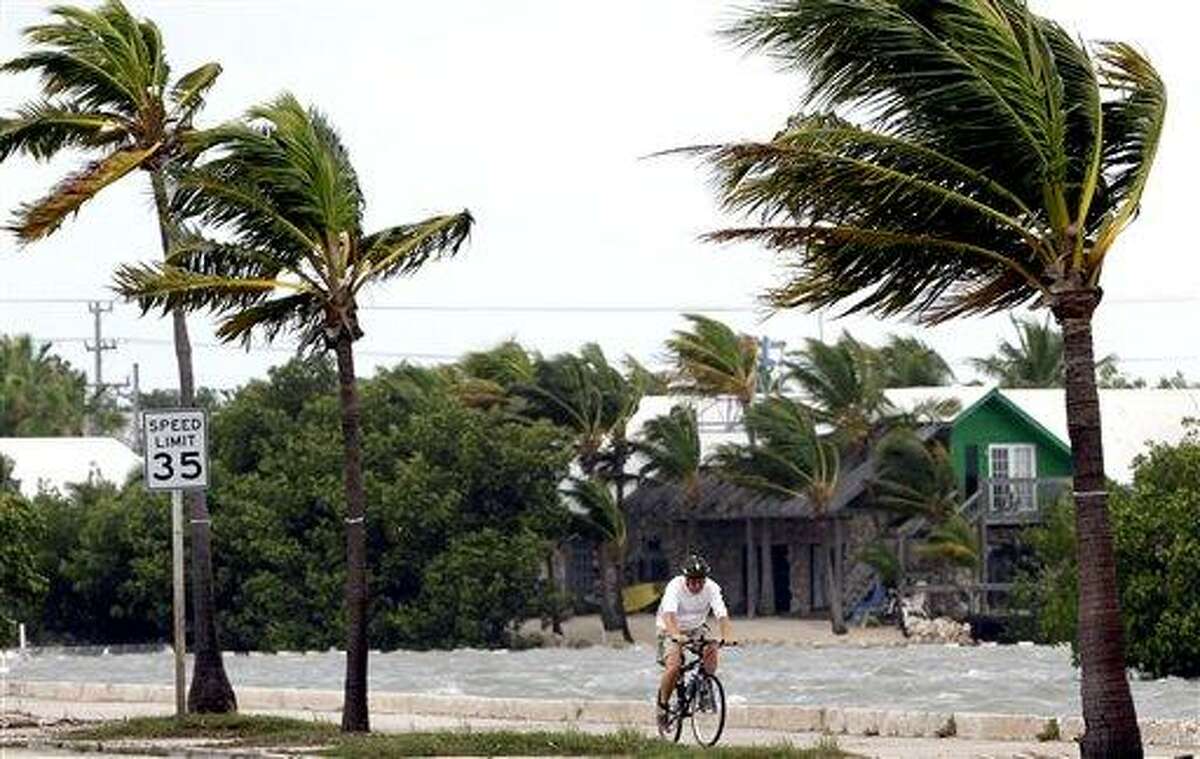 A cyclist rides his bike in Key West, Fla., Sunday, as Tropical Storm Isaac gained fresh muscle. Associated Press Photo