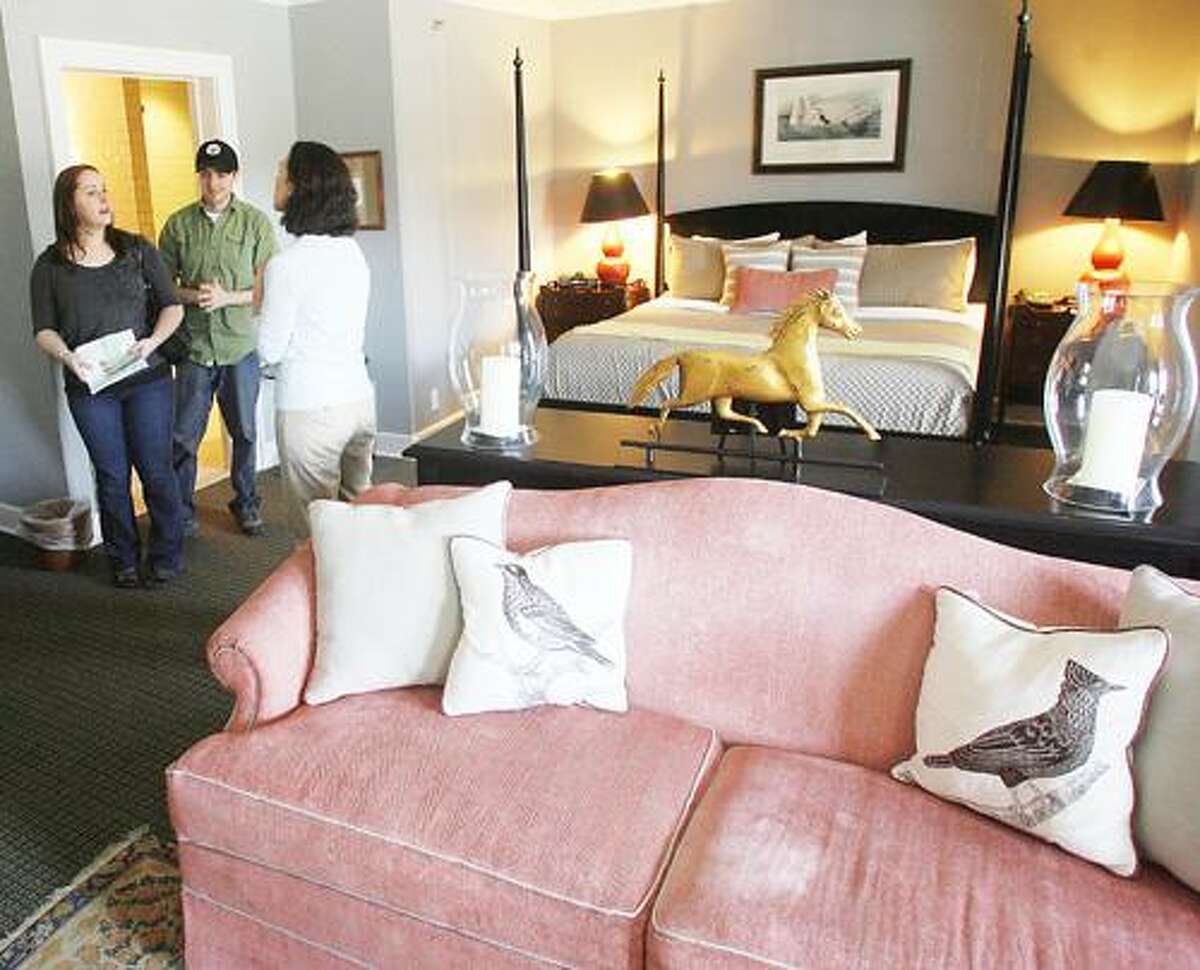 Photo by JOHN HAEGER (Twitter.com/OneidaPhoto) Jana Truett Crouch of the Colgate Inn shows Katey Moskiewicz and Matthew King of Prospect a suite at the inn during a wedding tour on Sunday, April 30, 2012, in Hamilton.