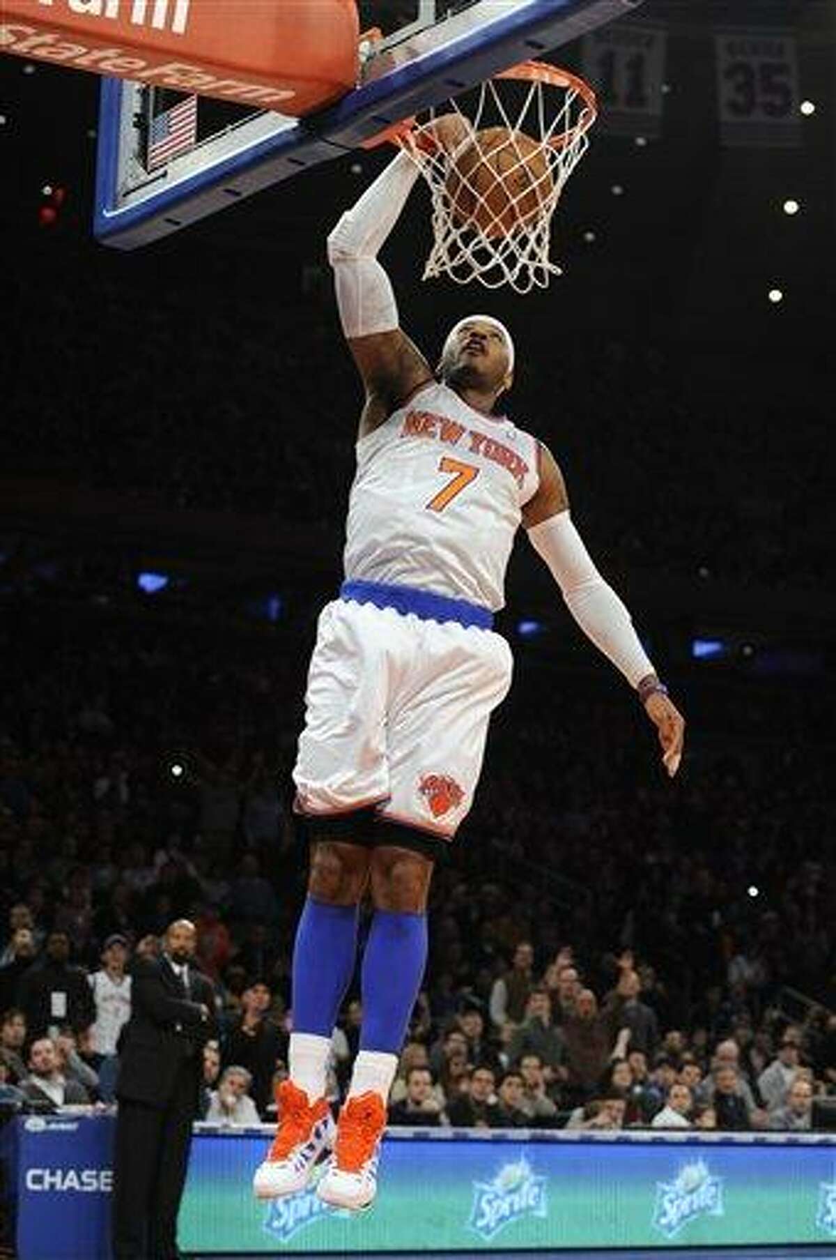 New York Knicks' Carmelo Anthony (7) dunks a basket against the Minnesota Timberwolves in the first half of an NBA basketball game on Sunday, Dec., 23, 2012, at Madison Square Garden in New York. (AP Photo/Kathy Kmonicek)