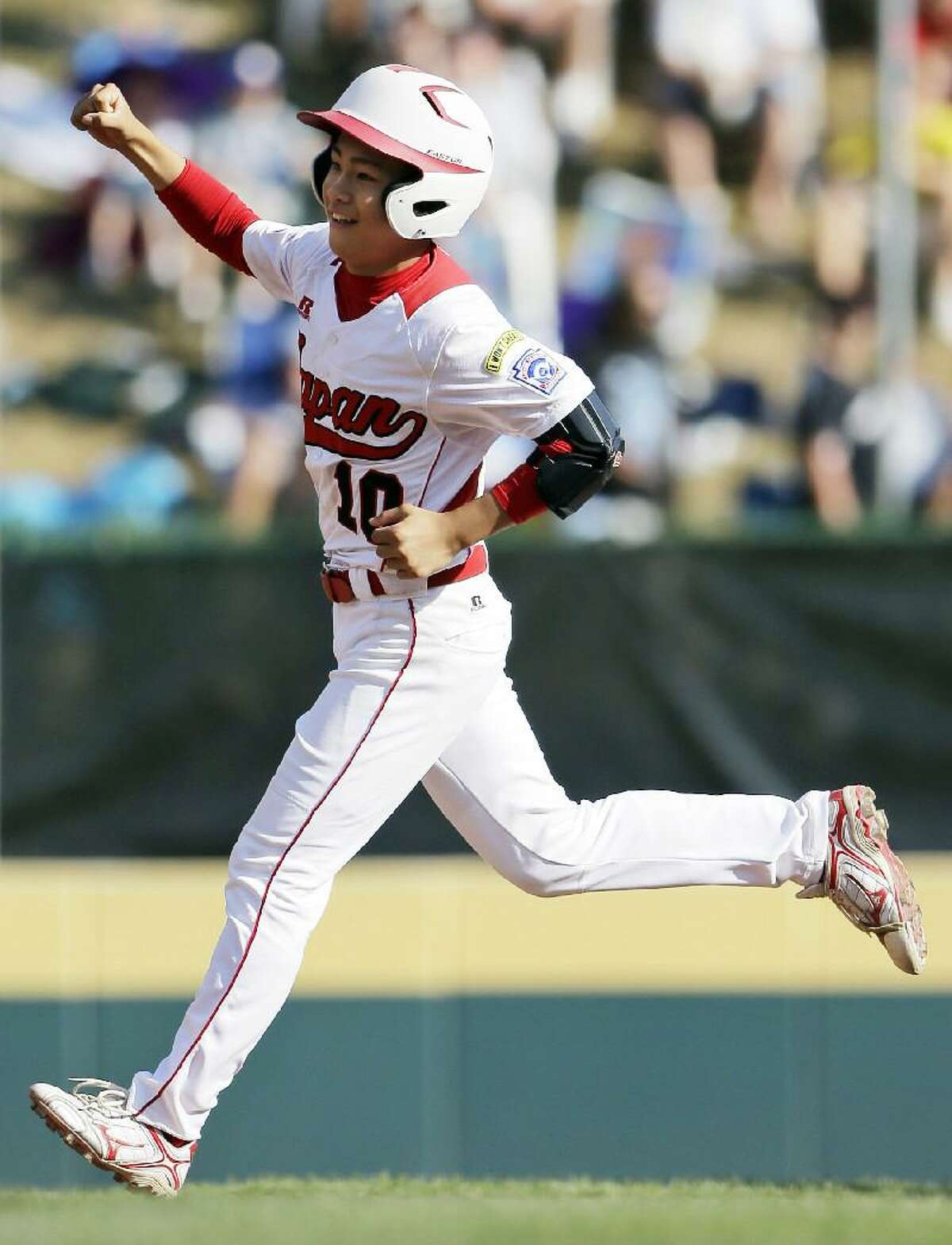 ASSOCIATED PRESS Tokyo, Japan's Noriatsu Osaka celebrates as he rounds the bases after hitting a two-run home run in the fifth inning of the Little League World Series championship baseball game against Goodlettsville, Tenn., Sunday in South Williamsport, Pa. Japan won 12-2 in five innings.