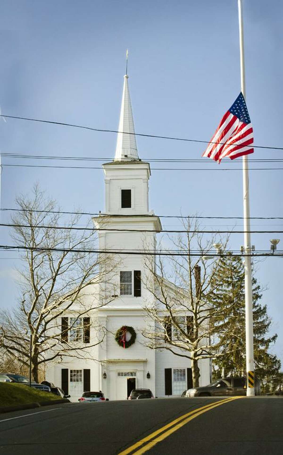 The American flag flies at half mast near the Community Meeting House church. Melanie Stengel/Register