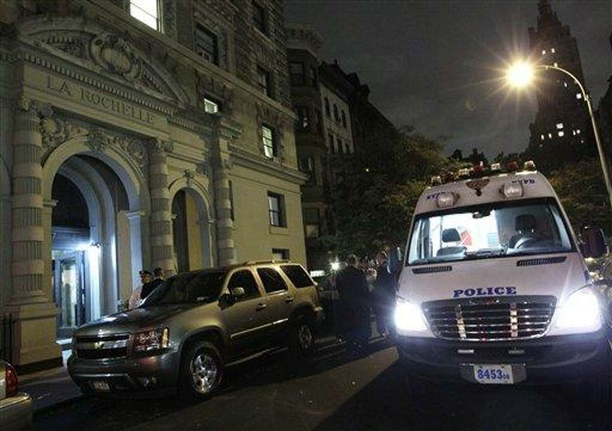 A police crime scene vehicle is parked in front of the luxury Manhattan apartment building where police say a nanny stabbed two small children to death in a bathtub and then stabbed herself in New York, Thursday, Oct. 25, 2012. Police say the children's mother found the scene after returning home with another child. (AP Photo/Kathy Willens)