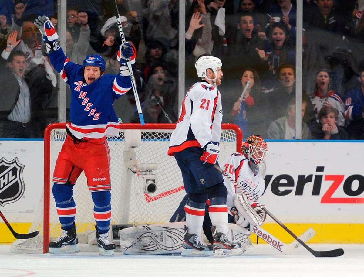 New York Rangers' Ruslan Fedotenko (L) celebrates teammate Artem Anisimov's (not seen) goal in front of Washington Capitals' Brooks Laich (C) and goalie Braden Holtby in the second period during Game 1 of their NHL Eastern Conference semi-final playoff hockey game at Madison Square Garden in New York, April 28, 2012. REUTERS/Ray Stubblebine (UNITED STATES - Tags: SPORT ICE HOCKEY)