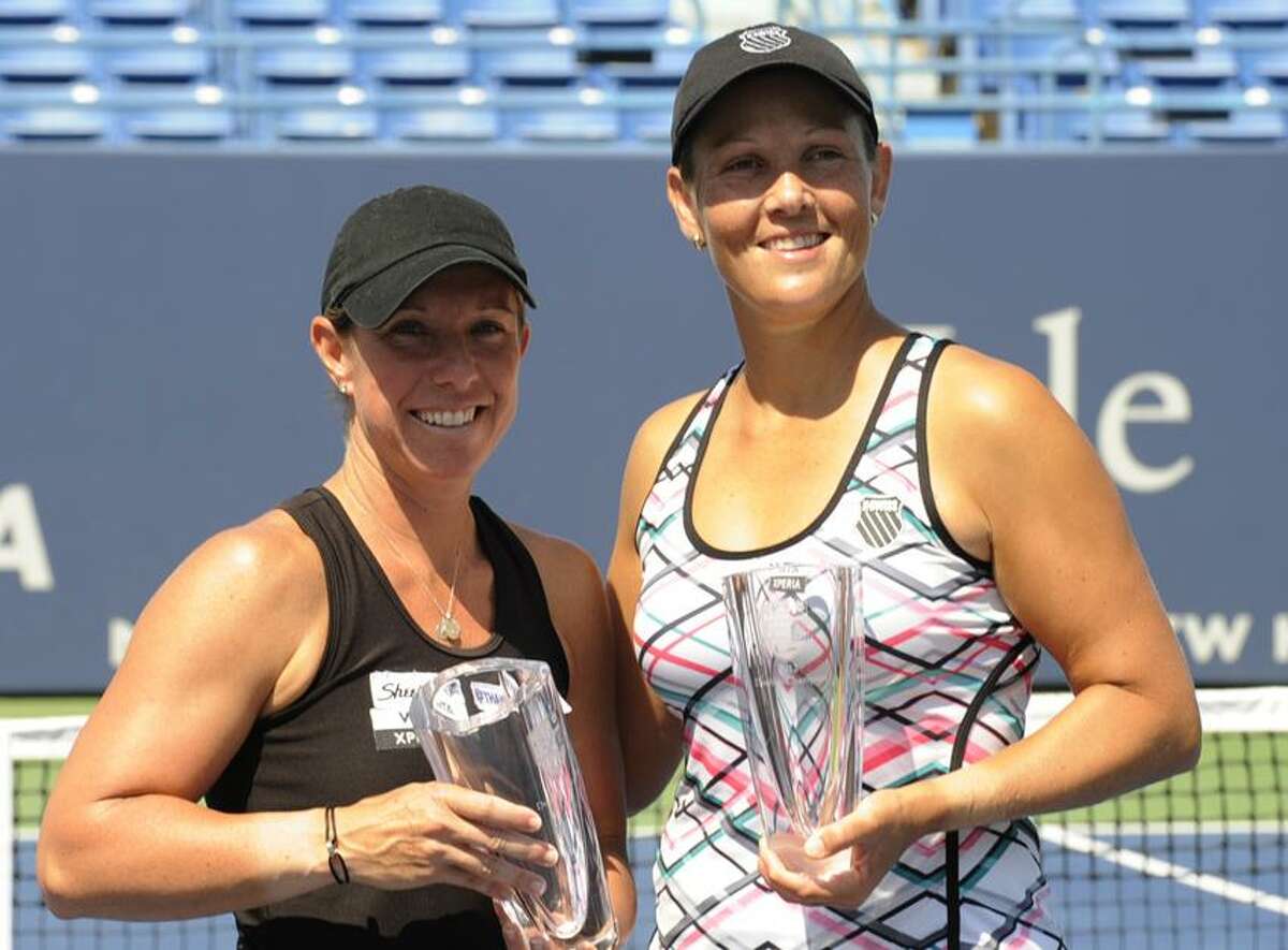 Lisa Raymond, left, and Liezel Huber won the New Haven Open doubles championship on Saturday at the Connecticut Tennis Center at Yale. (Bob Child/Special to the Register)