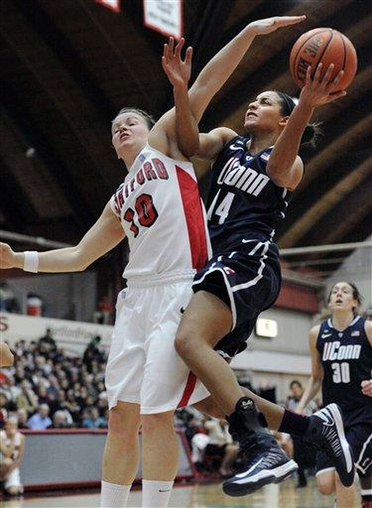 Connecticut's Bria Hartley, right is fouled by Hartford's Alex Hall, left, during the first half of an NCAA women's college basketball game at the Hartford, Saturday, Dec. 22, 2012, in West Hartford, Conn. (AP Photo/Jessica Hill)