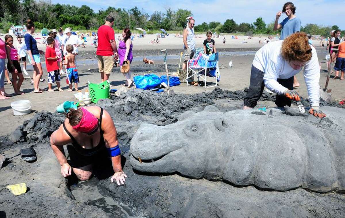 Ellen Croll (left) and her sister, Fran Preban (right), of Milford work on Big Mamma, a hippo, at the Great American Sand Sculpture Competition in Milford on 8/25/2012. This placed first in the family category.Photo by Arnold Gold/New Haven Register