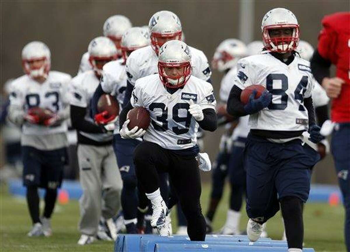 New England Patriots running back Danny Woodhead (39) and wide receiver Deion Branch (84) run a drill during NFL football practice at Gillette Stadium in Foxborough, Mass., Wednesday, Dec. 19, 2012. (AP Photo/Michael Dwyer)
