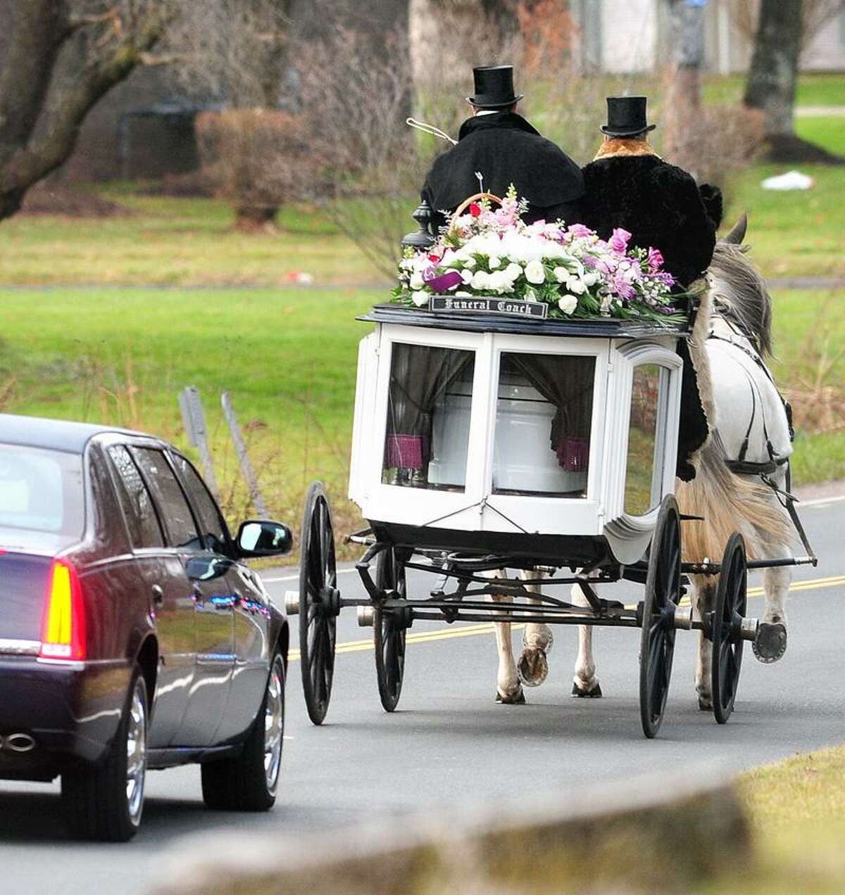 A horse drawn funeral coach carries the body of Sandy Hook Elementary School shooting victim Ana Grace Marquez-Greene from funeral services at The First Cathedral in Bloomfield on 12/22/2012. On the carriage are Randy Franklin (left) and John Allegra (right) of Allegra Farm. Photo by Arnold Gold/New Haven Register