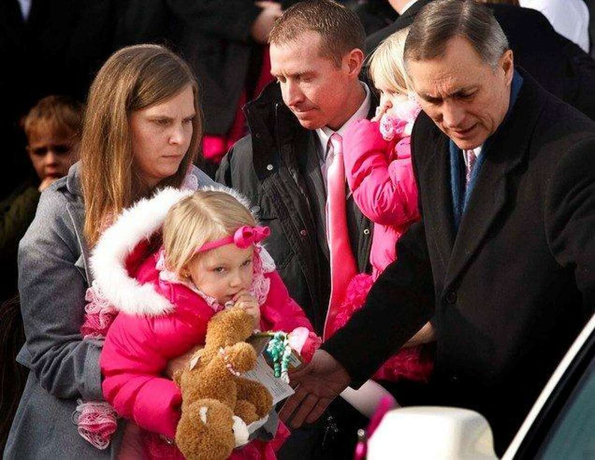 Robbie Parker carries daughter Madeline, 4, and Alissa Parker carries Samantha, 2, from the funeral service for their oldest daughter Emilie, Saturday December 22, 2012 in Ogden. Funeral services for Connecticut elementary shooting victim Emilie Parker were held in Ogden at the at the Rock Cliff LDS Stake Center. Emilie, whose family has Ogden roots, was one of 20 children and six adult victims killed in the Dec. 14 mass shooting at Sandy Hook Elementary in Newtown, Conn. The shooting took the lives of 26 people, before the gunman killed himself. Leah Hogsten