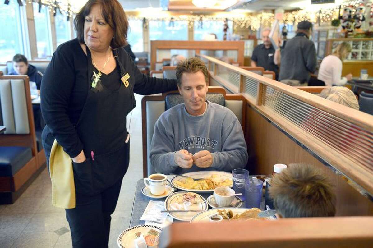 Nora Edery , a 25-year employee of the Blue Colony Diner, exclaimed that her favorite customers had arrived when Mark Edwards, of Newtown, and his 7-year-old son Cole walked in for breakfast. She watched over the pair giving Cole a pair of umbrellas and a straw for his hot chocolate.The diner serves as a respite for the people affected by the Sandy Hook shooting last week. People of all walks of life, mourners, those in uniform, journalists, and visitors, sit side by side in the diner for a hot cup of coffee and a bite to eat. December 21, 2012. Photo by Mahala Gaylord