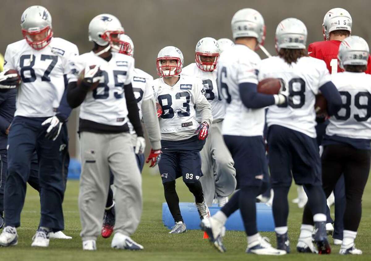 New England Patriots wide receiver Wes Welker (83) runs a drill with teammates during NFL football practice at Gillette Stadium in Foxborough, Mass., Wednesday, Dec. 19, 2012. (AP Photo/Michael Dwyer)