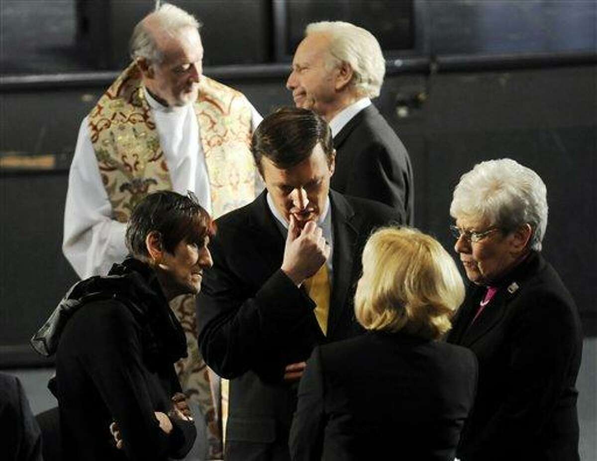 U.S. Sen. Joseph Lieberman, I-Conn., top right, Rep. Rosa DeLauro, D-Conn., left, Sen-elect Chris Murphy, center, and Lt. Gov. Nancy Wyman, right, wait for the arrival of President Barack Obama before the start of an interfaith vigil for the victims of the Sandy Hook Elementary School shooting inside the Newtown High School auditorium in Newtown, Conn., Sunday night, Dec. 16, 2012. A gunman walked into the elementary school Friday and opened fire, killing 26 people, including 20 children. (AP Photo/The Hartford Courant, Stephen Dunn, Pool)