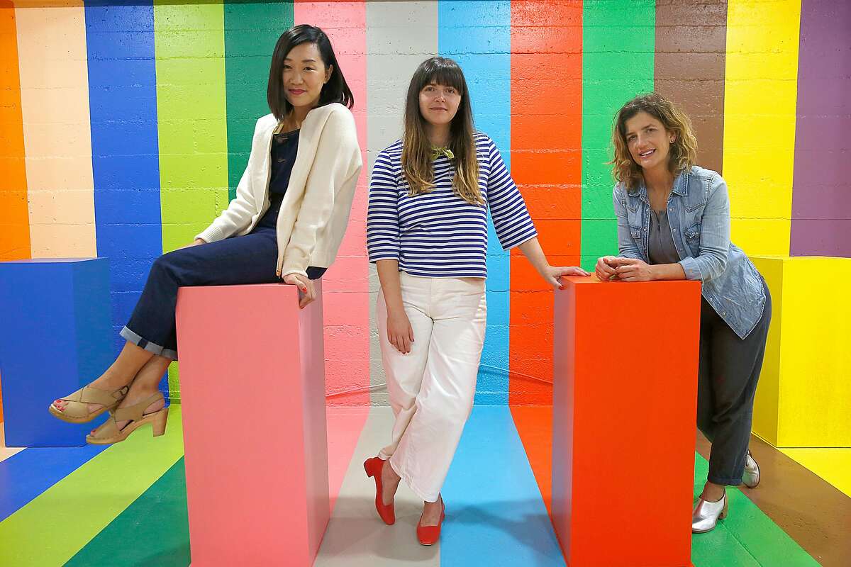 Art direction and design Erin Jang (left), founder Jordan Ferney (middle), and creative direction Leah Rosenberg (right) in the scratch and sniff room is part of the Color Factory two-story interactive exhibition on Tuesday, July 25, 2017, in San Francisco, Calif.