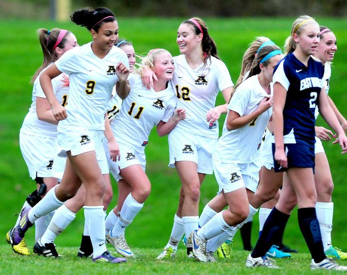 Amity players congratulate Dakota Kelly (11) after she scored a goal to put Amity up 2-0 in the first half against East Haven. Amity won 3-0. Photo by Arnold Gold/New Haven Register